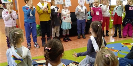 Powiększ grafikę: Dzieci stoją w kole. W rękach trzymają tablice z bałwankami